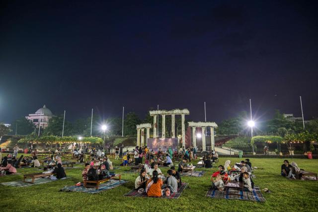 People gather during the 'Night at the Museum 2025' event at the Heroes Monument, near the 10 November Museum in Surabaya on November 29, 2025. (Photo by Juni KRISWANTO / AFP)
