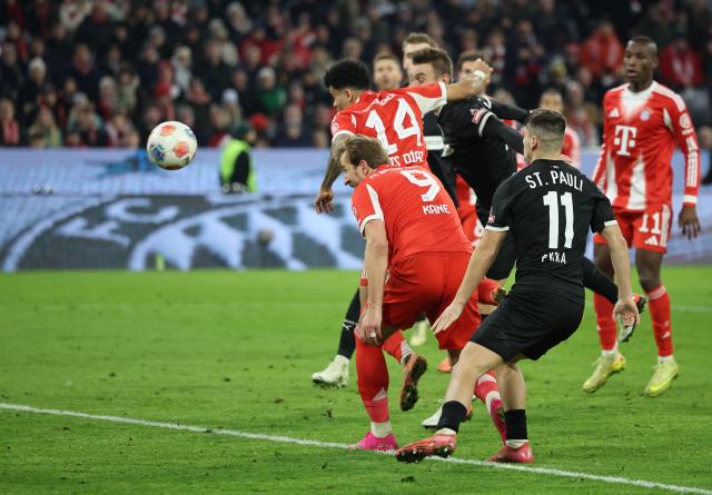 Bayern Munich's Colombian forward #14 Luis Diaz (C) heads the ball to score the 2-1 during the German first division Bundesliga football match between FC Bayern Munich and FC St Pauli in Munich, southern Germany on November 29, 2025. (Photo by Alexandra BEIER / AFP) / DFL REGULATIONS PROHIBIT ANY USE OF PHOTOGRAPHS AS IMAGE SEQUENCES AND/OR QUASI-VIDEO