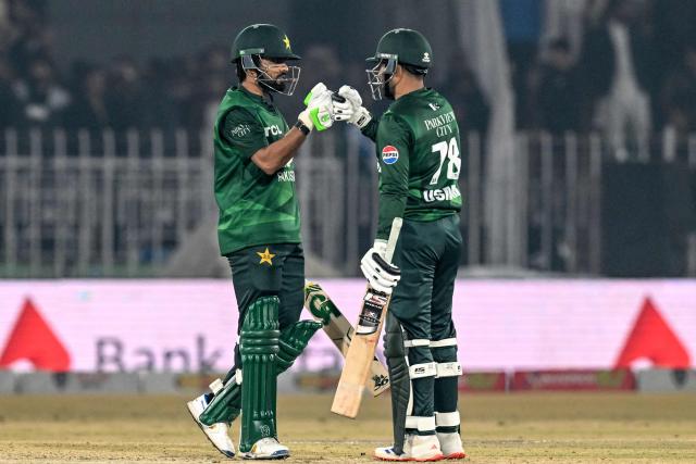Pakistan' Babar Azam (L) and Usman Khan celebrate after winning the Twenty20 international Tri-Series final cricket match between Pakistan and Sri Lanka at the Rawalpindi Cricket Stadium in Rawalpindi on November 29, 2025. (Photo by Aamir QURESHI / AFP)