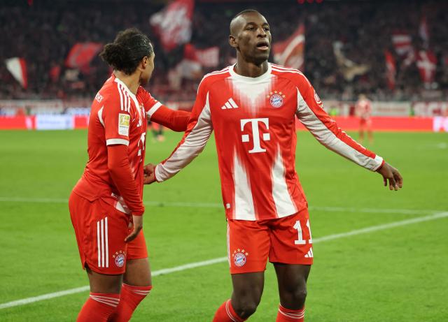 Bayern Munich's Senegalese forward #11 Nicolas Jackson (R) celebrates his 3-1 during the German first division Bundesliga football match between FC Bayern Munich and FC St Pauli in Munich, southern Germany on November 29, 2025. (Photo by Alexandra BEIER / AFP) / DFL REGULATIONS PROHIBIT ANY USE OF PHOTOGRAPHS AS IMAGE SEQUENCES AND/OR QUASI-VIDEO