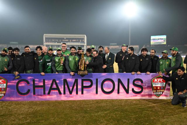 Pakistan's players and team officials pose with trophy at the end of the Twenty20 International Tri-Series final between Pakistan and Sri Lanka at Rawalpindi Cricket Stadium on November 29, 2025. (Photo by Aamir QURESHI / AFP)