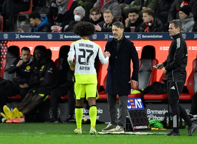 Dortmund's Croatian head coach Niko Kovac (C) speaks to Dortmund's German forward #27 Karim Adeyemi (L) during the German first division Bundesliga football match between Bayer 04 Leverkusen and Borussia Dortmund in Leverkusen, western Germany, on November 29, 2025. (Photo by INA FASSBENDER / AFP) / DFL REGULATIONS PROHIBIT ANY USE OF PHOTOGRAPHS AS IMAGE SEQUENCES AND/OR QUASI-VIDEO