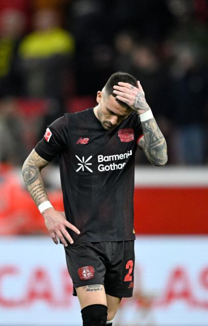 Bayer Leverkusen's Spanish midfielder #24 Aleix Garcia reacts after the German first division Bundesliga football match between Bayer 04 Leverkusen and Borussia Dortmund in Leverkusen, western Germany, on November 29, 2025. (Photo by INA FASSBENDER / AFP) / DFL REGULATIONS PROHIBIT ANY USE OF PHOTOGRAPHS AS IMAGE SEQUENCES AND/OR QUASI-VIDEO