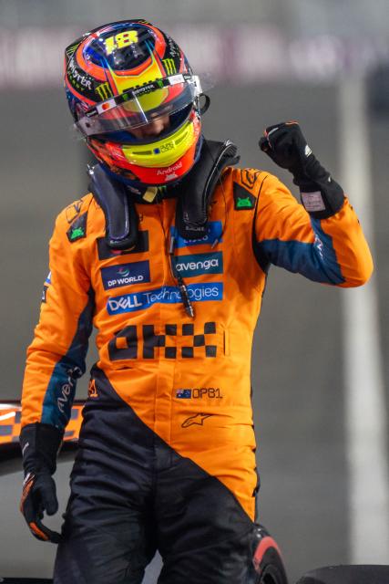 McLaren's Australian driver Oscar Piastri celebrates after securing pole position at the end of the qualifying session ahead of the Formula One Qatar Grand Prix at the Lusail International Circuit in Lusail on November 29, 2025. (Photo by Andrej ISAKOVIC / AFP)