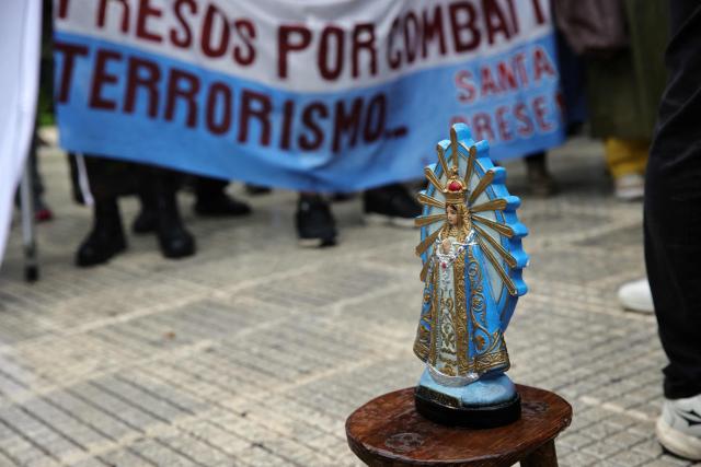 An image of the Virgin of Lujan is displayed during a demonstration by defenders of convicted perpetrators of genocide at Plaza de Mayo in Buenos Aires, on November 29, 2025. (Photo by Emiliano Lasalvia / AFP)