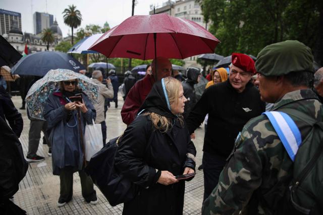 Defenders of convicted perpetrators of genocide demonstrate at Plaza de Mayo in Buenos Aires on November 29, 2025, wearing a black scarf instead of the traditional white one of the Human Right Activists Madres and Abuelas de Plaza de Mayo. (Photo by Emiliano Lasalvia / AFP)