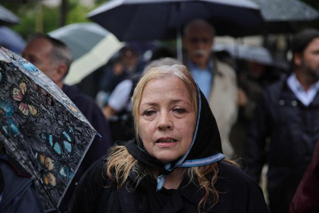 A defender of convicted perpetrators of genocide demonstrates at Plaza de Mayo in Buenos Aires on November 29, 2025, wearing a black scarf instead of the traditional white one of the Human Right Activists Madres and Abuelas de Plaza de Mayo. (Photo by Emiliano Lasalvia / AFP)