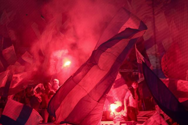 Marseille's supporters light flares during the French L1 football match between Olympique de Marseille (OM) and Touloue FC (TFC) at the Stade Velodrome in Marseille, southern France, on November 29, 2025. (Photo by Alex MARTIN / AFP)