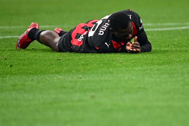AC Milan's French midfielder #19 Youssouf Fofana reacts lying on the field during the Italian Serie A football match between AC Milan and Lazio at the San Siro stadium in Milan on November 29, 2025. (Photo by Piero CRUCIATTI / AFP)