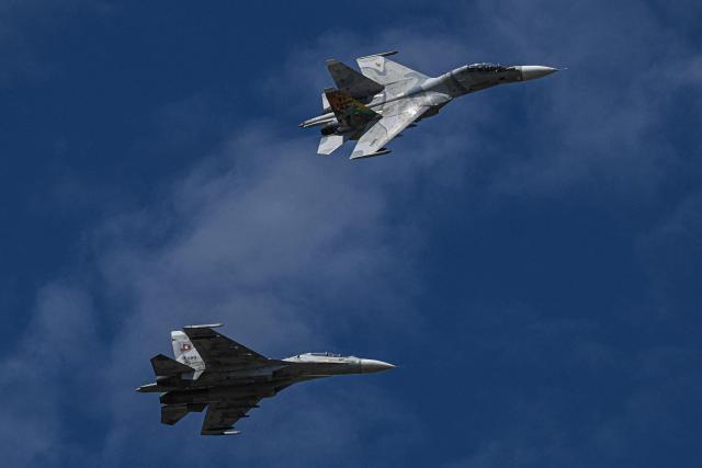 Russian-made Venezuelan Air Force Sukhoi Su-30MKV multirole strike fighters overflies during the 2025 Venezuela industrial aviation expo at the Libertador Air Base in Maracay, Aragua State, Venezuela, on November 29, 2025. (Photo by Federico PARRA / AFP)