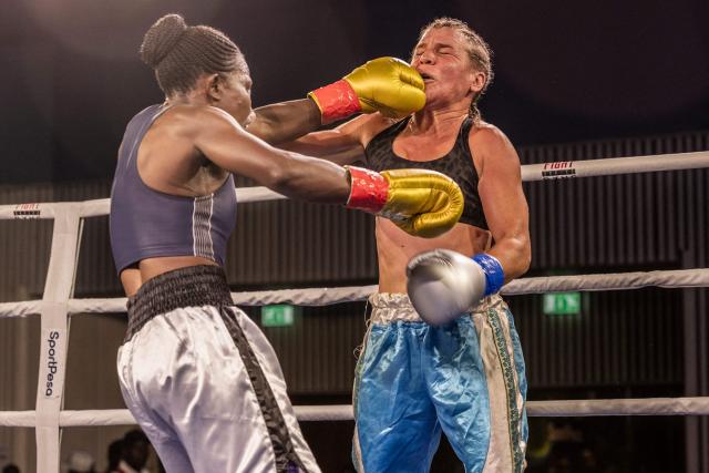 Kenya's Consolata Musangi (L) punches Sweden's Sandra Attermo (R) during their Women Super Bantamweight boxing title bout at the Edge Convention Centre, in Nairobi on November 30, 2025. (Photo by SIMON MAINA / AFP)