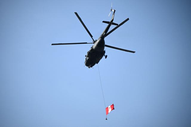 A helicopter waves the Peruvian flag during the all Brazilian Copa Libertadores final football match between Palmeiras and Flamengo at Monumental 'U' Marathon stadium in Lima on November 29, 2025. (Photo by ERNESTO BENAVIDES / AFP)