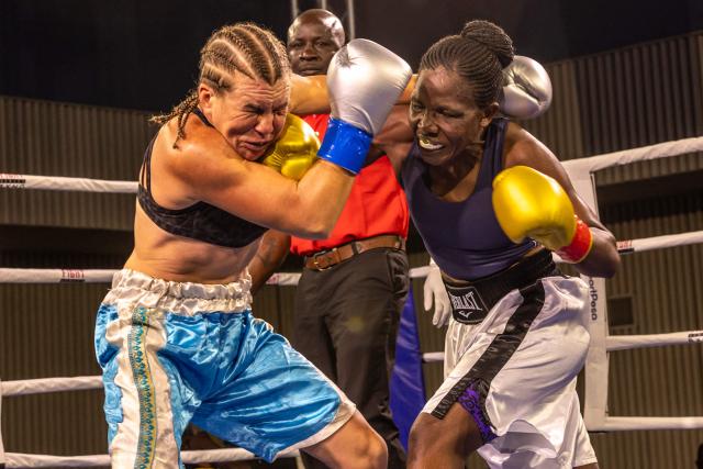 Sweden's Sandra Attermo (L) fights against Kenya's Consolata Musangi during their Women Super Bantamweight boxing title bout at the Edge Convention Centre, in Nairobi on November 30, 2025. (Photo by SIMON MAINA / AFP)
