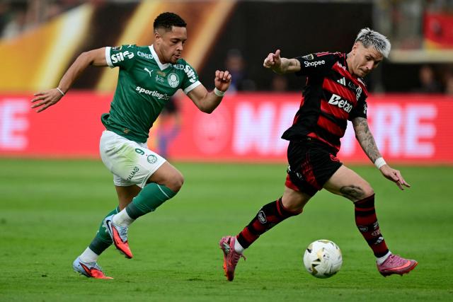 Palmeiras' forward #09 Vitor Roque (L) and Flamengo's Uruguayan defender #02 Guillermo Varela (R) fight for the ball during the all Brazilian Copa Libertadores final football match between Palmeiras and Flamengo at Monumental 'U' Marathon stadium in Lima on November 29, 2025. (Photo by ERNESTO BENAVIDES / AFP)
