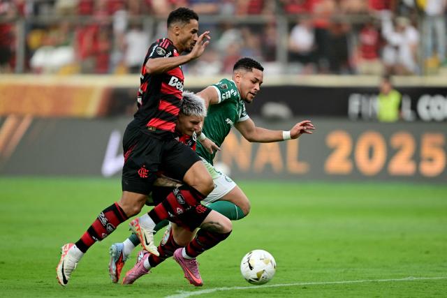 (L-R) Flamengo's defender #13 Danilo, Uruguayan defender #02 Guillermo Varela and Palmeiras' forward #09 Vitor Roque fight for the ball during the all Brazilian Copa Libertadores final football match between Palmeiras and Flamengo at Monumental 'U' Marathon stadium in Lima on November 29, 2025. (Photo by ERNESTO BENAVIDES / AFP)