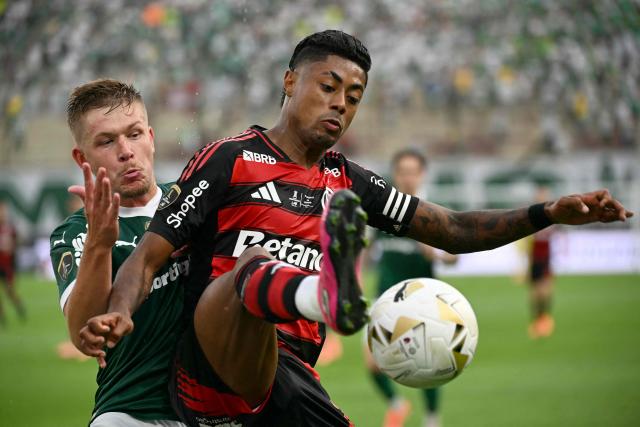 Flamengo's forward #27 Bruno Henrique (R) controls the ball past Palmeiras' defender #03 Bruno Fuchs (L) during the all Brazilian Copa Libertadores final football match between Palmeiras and Flamengo at Monumental 'U' Marathon stadium in Lima on November 29, 2025. (Photo by Luis ACOSTA / AFP)