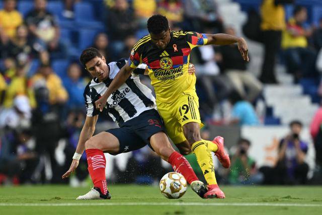 Monterrey's Colombian defender #33 Stefan Medina and America's Colombian forward #19 Jose Raul Zuniga fight for the ball during the Liga MX Apertura quarter-final second leg football match between America and Monterrey at Ciudad de los Deportes Stadium in Mexico City on November 29, 2025. (Photo by Yuri CORTEZ / AFP)