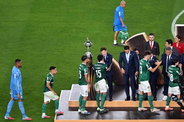 Palmeiras' Paraguayan defender #15 Gustavo Gomez and teammates receive the second-place medal from Conmebol's President Paraguayan Alejandro Dominguez during the ceremony award of the all Brazilian Copa Libertadores final football match between Palmeiras and Flamengo at Monumental 'U' Marathon stadium in Lima on November 29, 2025. (Photo by Connie FRANCE / AFP)