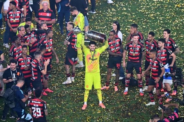 Flamengo's Argentine goalkeeper #01 Agustin Rossi lifts the the trophy after winning the all Brazilian Copa Libertadores final football match between Palmeiras and Flamengo at Monumental 'U' Marathon stadium in Lima on November 29, 2025. (Photo by Connie FRANCE / AFP)