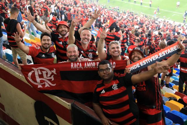 Flamengo's fans pose for a photo after winning the all Brazilian Copa Libertadores final football match between Palmeiras and Flamengo at Monumental 'U' Marathon stadium in Lima on November 29, 2025. (Photo by Connie FRANCE / AFP)