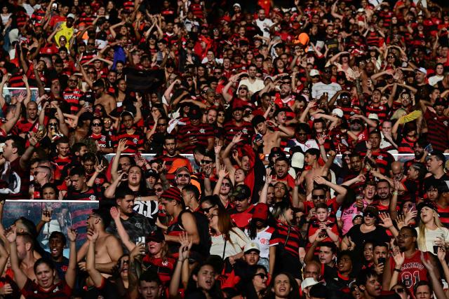 Flamengo fans celebrate after Flamengo defeated Palmeiras 1-0 in the all Brazilian Copa Libertadores final football match between Palmeiras and Flamengo on November 29, 2025, at the Maracana stadium in Rio de Janeiro, Brazil. (Photo by Pablo PORCIUNCULA / AFP)