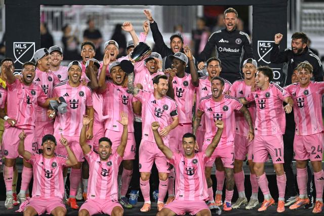 Inter Miami's Argentine forward #10 Lionel Messi (C) celebrates with the trophy after his team's victory in the Major League Soccer (MLS) Eastern Conference final football match between Inter Miami and New York City FC at Chase Stadium in Fort Lauderdale, Florida on November 29, 2025. Lionel Messi and Inter Miami reached the MLS Cup final for the first time on November 29, 2025 after a 5-1 thrashing of New York City FC in the Eastern Conference playoffs. (Photo by CHANDAN KHANNA / AFP)