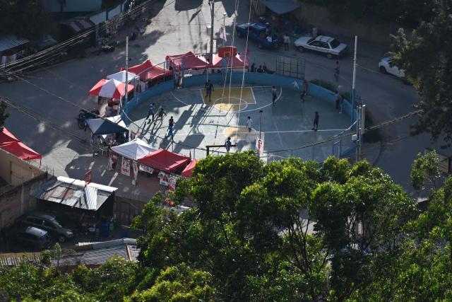 Children play on a field surrounded by electoral propaganda, in Tegucigalpa on November 29, 2025. Honduras will hold presidential elections on November 30, 2025. (Photo by Marvin RECINOS / AFP)