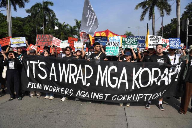 Protesters carrying placards march during an anti-corruption rally near a park on Manila on November 30, 2025. (Photo by TED ALJIBE / AFP)