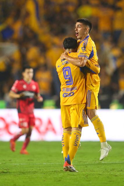 Tigres' Argentine midfielder #11 Juan Brunetta (R) celebrates with teammate Argentine forward #09 Nicolas Ibanez (L) after scoring his team's second goal during the Liga MX Apertura quarter-final second leg football match between Tigres and Tijuana at the UANL University Stadium in San Nicolas de los Garza, Nuevo Leon State, Mexico on November 29, 2025. (Photo by Julio Cesar AGUILAR / AFP)