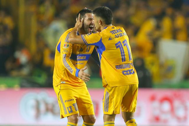 Tigres' Argentine midfielder #11 Juan Brunetta (R) celebrates with teammate French forward #10 Andre-Pierre Gignac (L) after scoring his team's second goal during the Liga MX Apertura quarter-final second leg football match between Tigres and Tijuana at the UANL University Stadium in San Nicolas de los Garza, Nuevo Leon State, Mexico on November 29, 2025. (Photo by Julio Cesar AGUILAR / AFP)