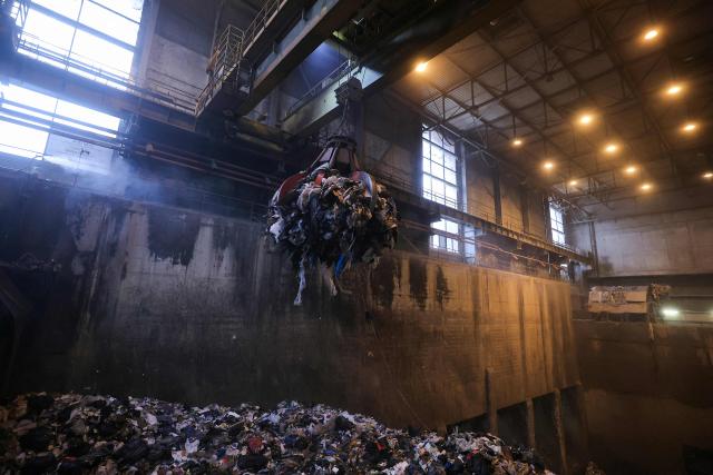 A photograph taken on November 25, 2025, shows a grapple taking mixed solid waste in a garbage pit to load the furnace at the Isseane Syctom incinerator of Issy-les-Moulineaux, in the outskirts of Paris. (Photo by Thomas SAMSON / AFP)