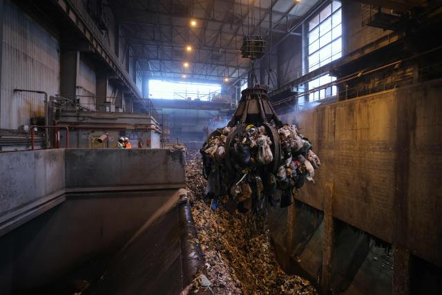 A photograph taken on November 25, 2025, shows a grapple taking mixed solid waste in a garbage pit to load the furnace at the Isseane Syctom incinerator of Issy-les-Moulineaux, in the outskirts of Paris. (Photo by Thomas SAMSON / AFP)