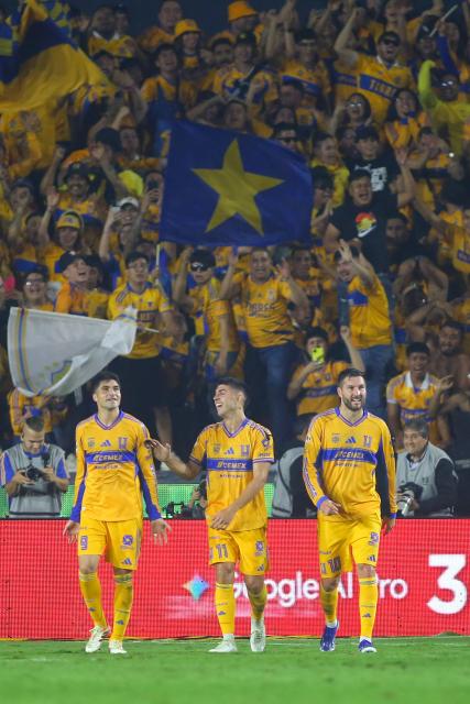 Tigres' Argentine midfielder #11 Juan Brunetta (C) celebrates with teammates Argentine forward #09 Nicolas Ibanez (L) and French forward #10 Andre-Pierre Gignac (R) after scoring his team's third goal during the Liga MX Apertura quarter-final second leg football match between Tigres and Tijuana at the UANL University Stadium in San Nicolas de los Garza, Nuevo Leon State, Mexico on November 29, 2025. (Photo by Julio Cesar AGUILAR / AFP)
