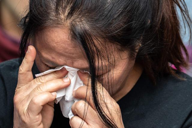 Philippine nationals in Hong Kong take part in a community prayer service for victims of the deadly November 26 fire at Tai Po, in Hong Kong’s Central district on November 30, 2025. An outpouring of grief swept Hong Kong on November 29, as thousands paid their respects and laid flowers for the 128 people killed in one of the city's deadliest fires, marking the start of an official three-day mourning period. (Photo by Philip FONG / AFP)