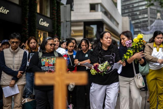 Philippine nationals in Hong Kong take part in a community prayer service for victims of the deadly November 26 fire at Tai Po, in Hong Kong’s Central district on November 30, 2025. An outpouring of grief swept Hong Kong on November 29, as thousands paid their respects and laid flowers for the 128 people killed in one of the city's deadliest fires, marking the start of an official three-day mourning period. (Photo by Philip FONG / AFP)