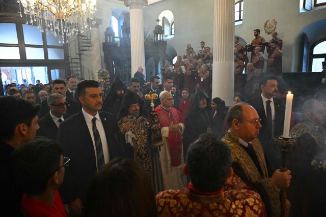 Pope Leo XIV is welcomed by Patriarch Sahak II (L) during a visit to the Armenian Apostolic Cathedral, in Istanbul on November 30, 2025. (Photo by Andreas SOLARO / AFP)