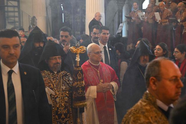 Pope Leo XIV is welcomed by Patriarch Sahak II (L) during a visit to the Armenian Apostolic Cathedral, in Istanbul on November 30, 2025. (Photo by Andreas SOLARO / AFP)