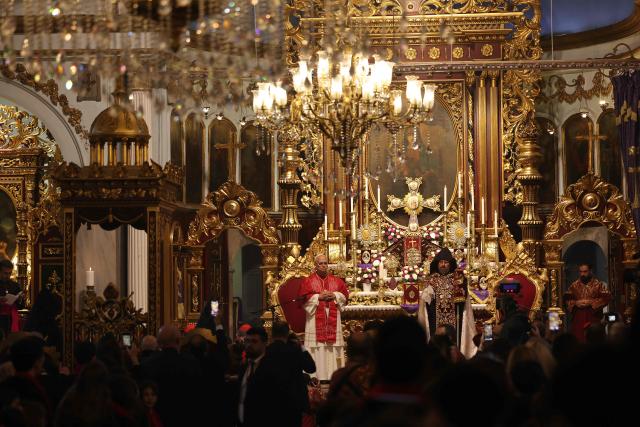 Pope Leo XIV is welcomed by Patriarch Sahak II during a visit to the Armenian Apostolic Cathedral, in Istanbul on November 30, 2025. (Photo by BERK OZKAN / AFP)