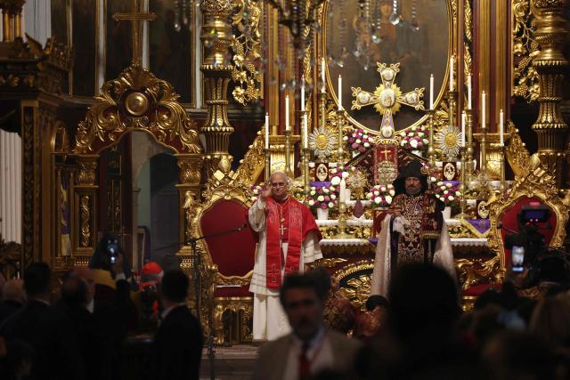Pope Leo XIV stands next to Patriarch Sahak II during a visit to the Armenian Apostolic Cathedral, in Istanbul on November 30, 2025. (Photo by BERK OZKAN / AFP)