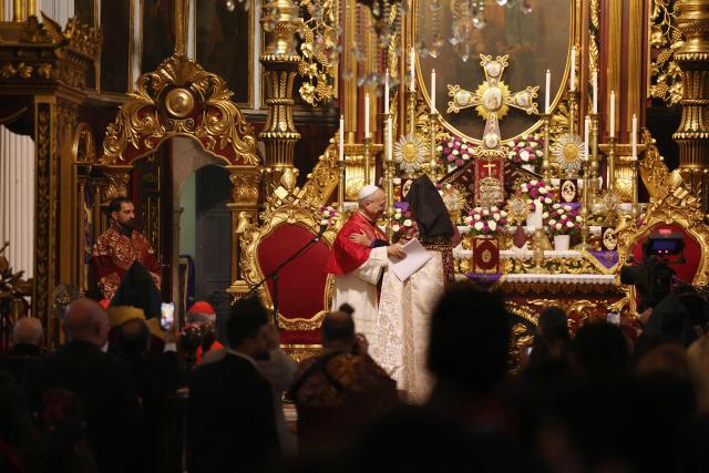 Pope Leo XIV is welcomed by Patriarch Sahak II during a visit to the Armenian Apostolic Cathedral, in Istanbul on November 30, 2025. (Photo by BERK OZKAN / AFP)