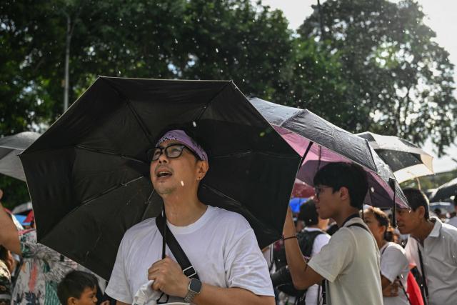 Protesters take part in an anti-corruption rally along Epifanio de los Santos Avenue, or EDSA, in Quezon City, Metro Manila on November 30, 2025. Thousands massed in the Philippine capital on November 30 demanding accountability over a multi-billion-dollar infrastructure scandal that has seen scores of officials, lawmakers and construction firm owners accused of corruption. (Photo by Jam STA ROSA / AFP)