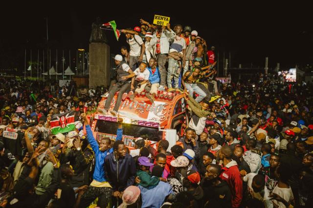 Members and fans of the ‘Opposite Nganya’ matatu -Kenya’s iconic, privately owned public transport minibus- drive around the venue celebrating their victory as Best Matatu during the 4th Nganya Awards in Nairobi on November 29, 2025. The Nganya Awards is a celebration of Kenya’s matatu culture, honoring the matatu scene and the unique lifestyle around them. This years awards had over 40 categories, from matatu crews to vehicle designers, sound system and social influencers linked to the matatu lifestyle, with voting taking place ahead of the award show. (Photo by Fredrik LERNERYD / AFP)