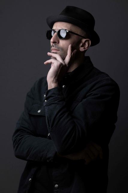 French photographer and street artist JR poses in his Paris studio on November 26, 2025. JR has presented 'The Cave of the Pont Neuf' the artwork he will create as a tribute to Christo and Jeanne-Claude, transforming the Pont Neuf forty years after the wrapping of Paris's oldest bridge. This work will be on display from June 6 to 28, 2026. (Photo by JOEL SAGET / AFP)