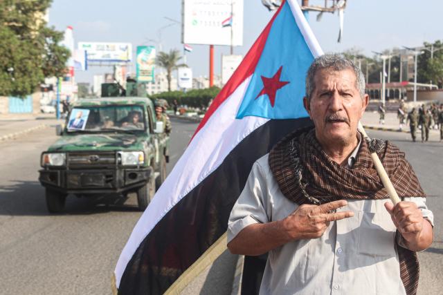 A man hols a People's Republic of South Yemen flag on the 58th anniversary of National Independence Day in the port city of Aden, in the southern part of the Arabian peninsula on November 30, 2025. Yemen's National Independence Day commemorates the establishment of the People’s Republic of South Yemen after more than 120 years of British presence centred around the port of Aden. (Photo by Saleh Al-OBEIDI / AFP)