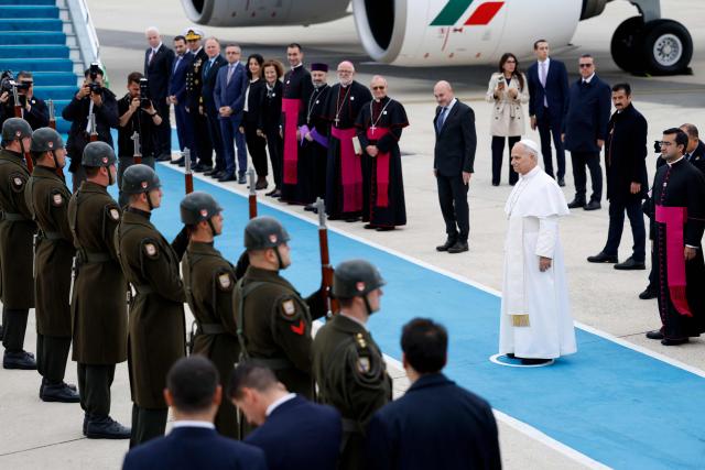 Pope Leo XIV (C) reviews troops as he leaves following a trip in Turkey, at Istanbul Ataturk airport, on November 30, 2025. (Photo by BERK OZKAN / AFP)