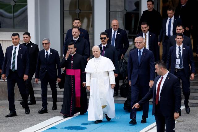 Pope Leo XIV (C) leaves following a trip in Turkey, at Istanbul Ataturk airport, on November 30, 2025. (Photo by BERK OZKAN / AFP)