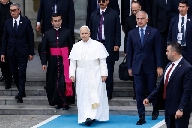 Pope Leo XIV (C) leaves following a trip in Turkey, at Istanbul Ataturk airport, on November 30, 2025. (Photo by BERK OZKAN / AFP)