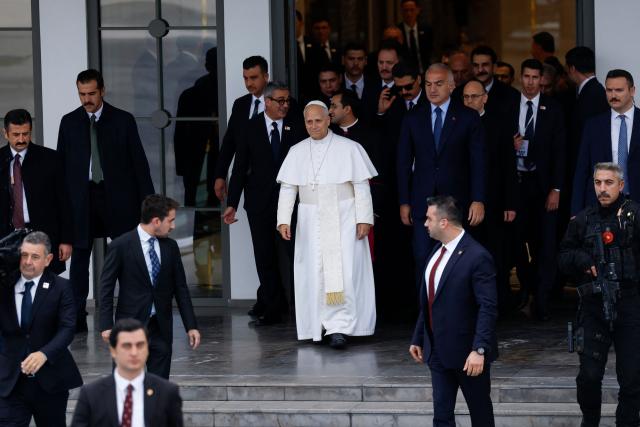 Pope Leo XIV (C) leaves following a trip in Turkey, at Istanbul Ataturk airport, on November 30, 2025. (Photo by BERK OZKAN / AFP)