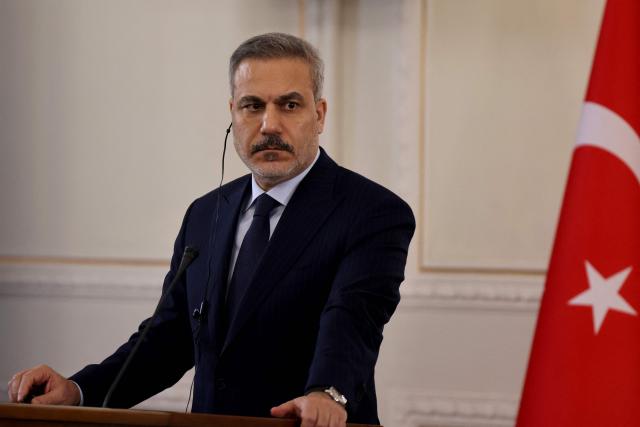 Turkey's Foreign Minister Hakan Fidan listens to Iran's Foreign Minister during a joint press conference, in Tehran on November 30, 2025. (Photo by ATTA KENARE / AFP)