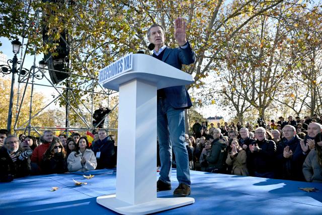 Spain's opposition right-wing Popular Party (PP) leader Alberto Nunez Feijoo speaks on a podium bearing the writing 'Elections now' during a demonstration against corruption called by the PP in front of Debod Temple in Madrid on November 30, 2025. (Photo by Javier SORIANO / AFP)